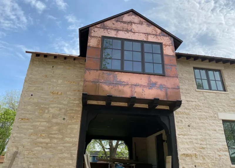 Copper metal panel facade on a stone building for Skylight Installation in Hazel Crest